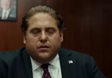 A frustrated man rubbing his eyes